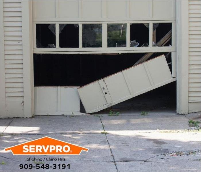 A damaged garage door is shown.
